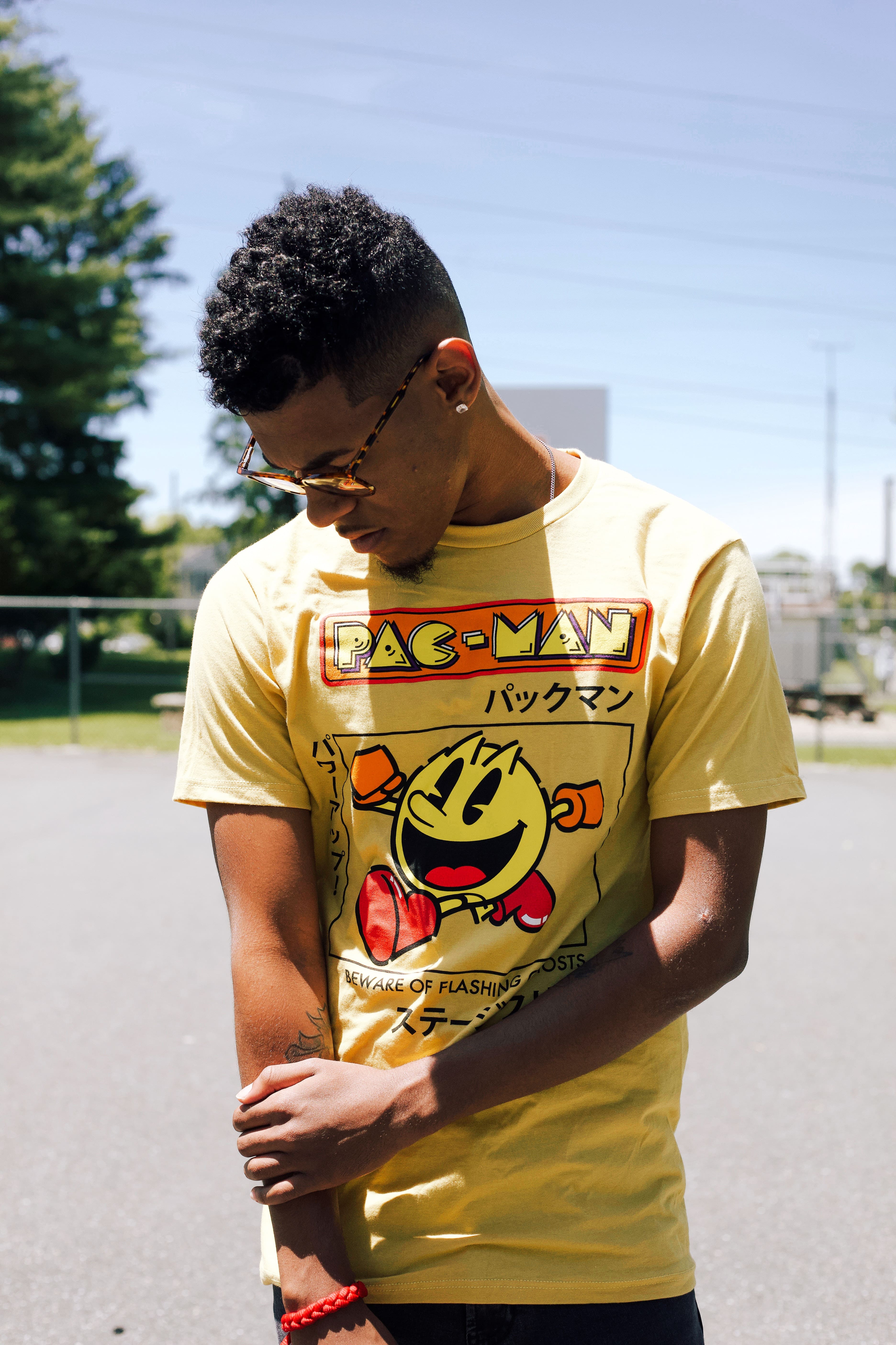 a young boy wearing customized designs yellow t shirt of Pac-man